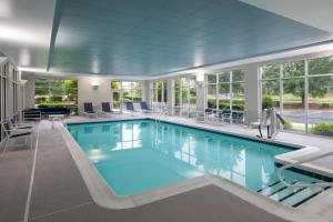 Hampton Inn & Suites Southern Pines-Pinehurst في Aberdeen: حمام سباحة بمياه زرقاء في مبنى
