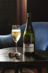 a bottle of wine and a glass on a table at Kempinski Hotel Berchtesgaden in Berchtesgaden