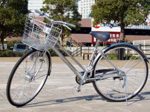 a bike with a basket parked on a street at Hotel Crown Hills Takaoka in Takaoka