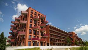a building with red balconies on the side of it at Maritime Suite an der Geeste in Bremerhaven