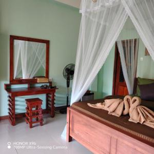 a bedroom with a bed with a mirror and a desk at Zen Garden Palace in Ella +40 photos