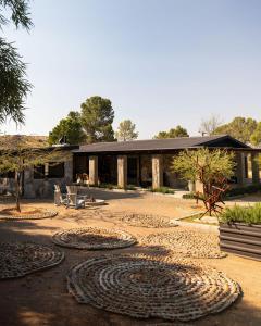 a building with a lot of rugs in front of it at Twyfelberg Karoo Hideaway in Britstown