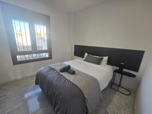 a bedroom with a large bed and two windows at Villa exceptionnelle avec piscine privée et terrasse in Villamartin +26 photos