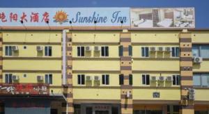 a building with a sign on the side of it at Sunshine Inn in Bintulu