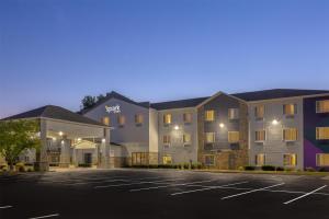 a hotel with a parking lot in front of it at Spark By Hilton Ames in Ames