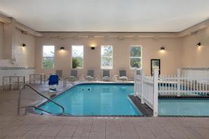 a large swimming pool in a hotel room at Spark By Hilton Ames in Ames