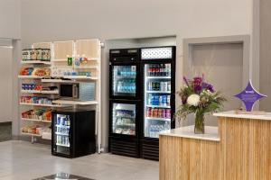 a store with an open refrigerator with food inside at Spark By Hilton Ames in Ames