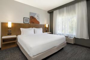 a hotel room with a large bed and a window at Spark By Hilton Ames in Ames +51 photos