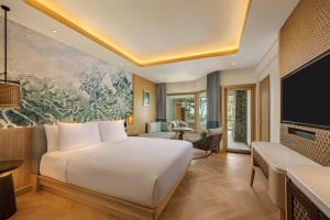 Ένα ή περισσότερα κρεβάτια σε δωμάτιο στο Mövenpick Resort & Spa Bintan Lagoon +16 φωτογραφίες