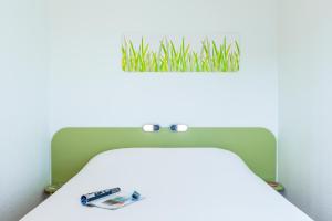 a hospital bed with a plant on top of it at ibis budget Issy Les Moulineaux Paris Ouest in Issy-les-Moulineaux