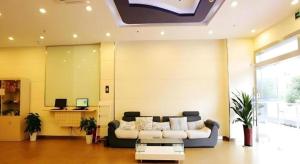 a living room with a couch and a table at 7 Days Inn Nanjing Jiangning University Town in Chunhua +72 photos