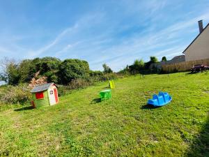 a field with two play equipment in the grass at Appart in Saint-Sauflieu