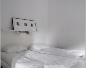 a white room with a bed with two pillows at Tott vacation homes in Åre +93 photos