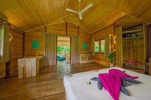 a bedroom with a bed in a wooden room at Jungle Beach Ahungalla in Ahungalla