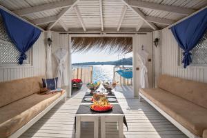 una sala da pranzo con tavolo e vista sull'acqua di Kefaluka Resort a Akyarlar