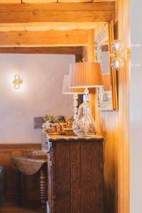 a lamp sitting on top of a wooden table at La Ferme a Mamy - Snowytrees in Morzine