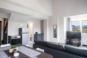 a living room with a couch and a table at Panorama Sunvilles Apartment 9 in Thessaloniki