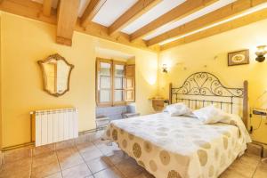 a bedroom with a large bed in a room at Cal Viudet Vell in Caserras