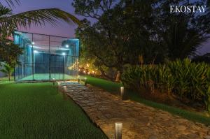 a rendering of a glass building at night at EKOSTAY - The Clay House in Alibaug