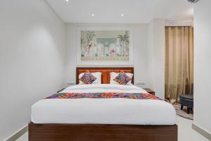 a bedroom with a large bed in a room at FabHotel Eraya in Varanasi