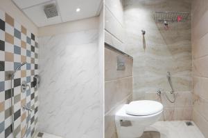 a bathroom with a toilet and a shower at FabHotel Eraya in Varanasi