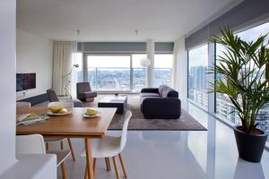 a living room with a table and chairs and a couch at Urban Residences Rotterdam in Rotterdam