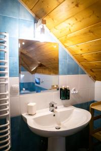 a bathroom with a sink and a mirror at Chill on Hill - Szczyrk in Szczyrk