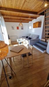 a living room with a table and a couch at NIMBO Apartment in Sierra Nevada
