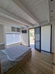 a bedroom with a bed and a large window at Chalet Los Molinos in La Oliva +46 photos