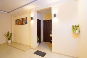 a room with a hallway with a toilet and a sink at FabHotel Club Metro in Nagpur