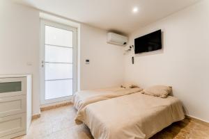 Ένα ή περισσότερα κρεβάτια σε δωμάτιο στο Canto Cigalo Rdc 2