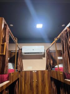 a view of the inside of a bus with a bed at Nestdormitory in Cochin +5 photos