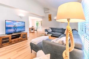 a living room with a couch and a lamp at The Nature Nook in Upper Mudgeeraba