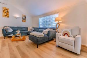 a living room with a blue couch and a chair at The Nature Nook in Upper Mudgeeraba