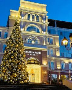 a christmas tree in front of a building at Stadium Park Hotel in Odesa