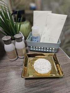 a table with a tray with a cookie and a box of soap at Áron Apartman in Tiszafüred +16 photos