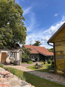 a home with a yard with a house at Sodyba Viltis in Bikavėnai