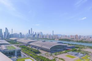 an aerial view of a building with a city in the background at Prime Pazhou Aparthotel - Pazhou Station Line 8 and 11 - Steps away from Canton Exhibition Center in Guangzhou