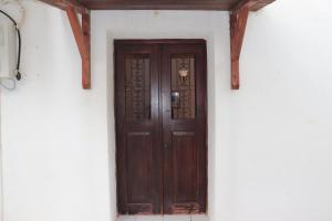 a wooden door in the corner of a building at Bougainvillea in Andros +3 photos