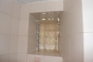 a shower with a glass door in a bathroom at Bougainvillea in Andros