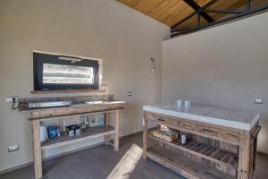 a room with a table and a tv on a wall at Tuscan Cozy Escape with View, Garden & Breakfast in CastellʼAzzara