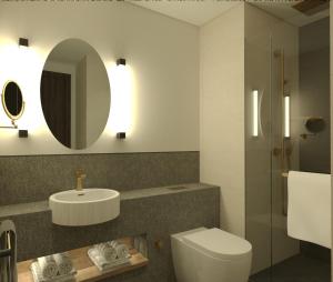 a bathroom with a toilet and a sink and a mirror at Ramada by Wyndham Arnavutkoy in Istanbul +11 photos