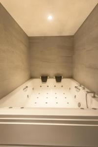 a large bath tub in a room with at Ramada by Wyndham Arnavutkoy in Istanbul