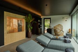 a living room with a couch and a chair at Hotel Lido in Ledro
