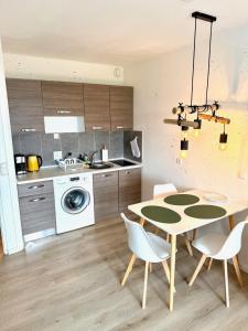 a kitchen with a table and chairs in a kitchen at Seebrise in Wendtorf