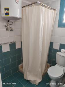 a bathroom with a shower curtain and a toilet at Elixir Two Bed Rooms in Hurghada +5 photos