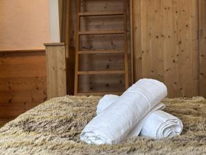 a stack of rolls of toilet paper on a pile of hay at Hôtel Les Airelles in La Clusaz +50 photos