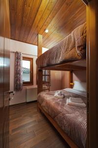 a bedroom with two bunk beds and a wooden ceiling at Pelion Horizon in Zagora