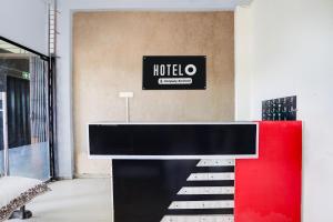 a hotel lobby with a red and black counter at Hotel O Wardha Road Near Airport in Nagpur
