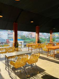 a group of tables and chairs on a patio at Ndalem Prabu Sarangan in Sarangan
